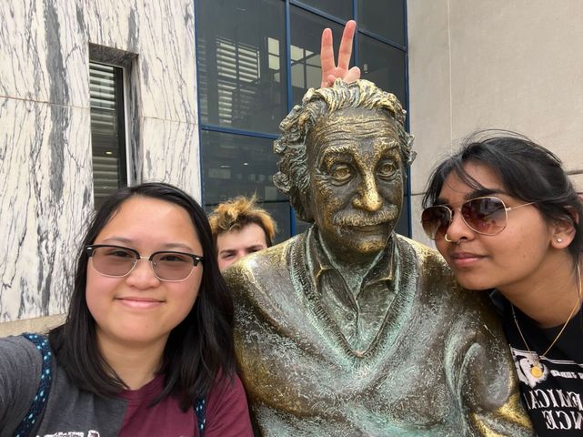Jenny Li and Ameera Hossain pose with a statue.
