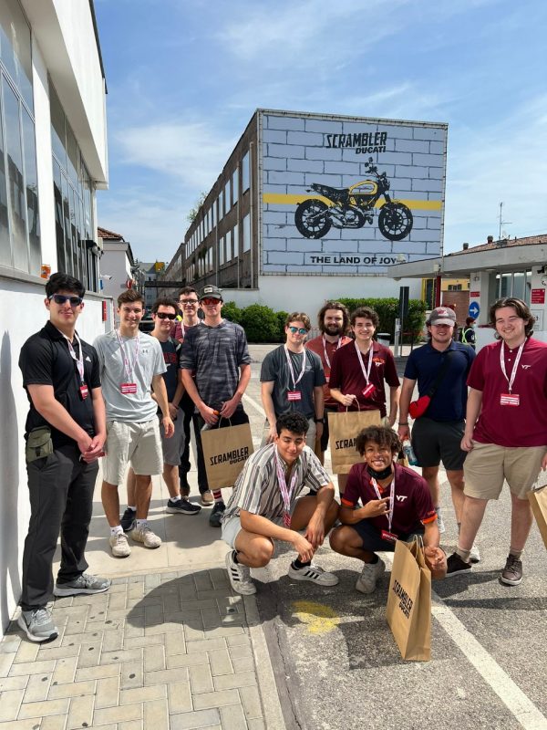 Students in front of a Ducati bulletin board in Italy.