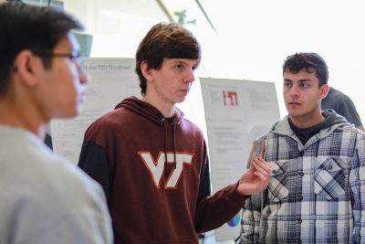 A student presents his 1414 project, turning the Hokie Passport into a wristband.