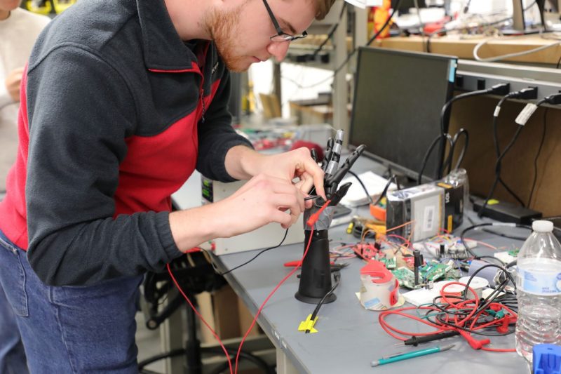 A student working on a robotic hand.