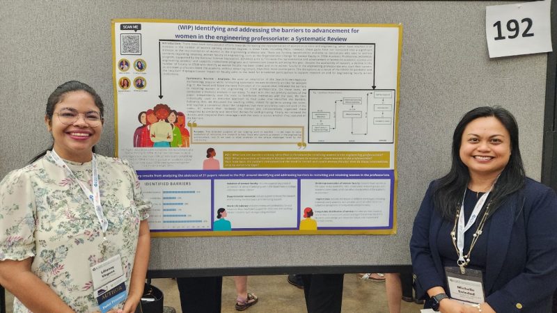 Michelle Soledad and Lilianny Virguez stand in front of their research.