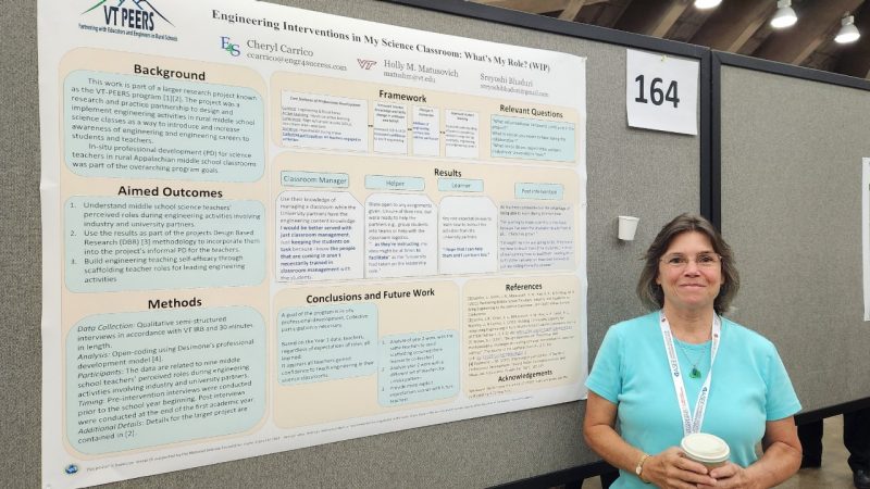 Cheryl Carrico stands in front of her research.