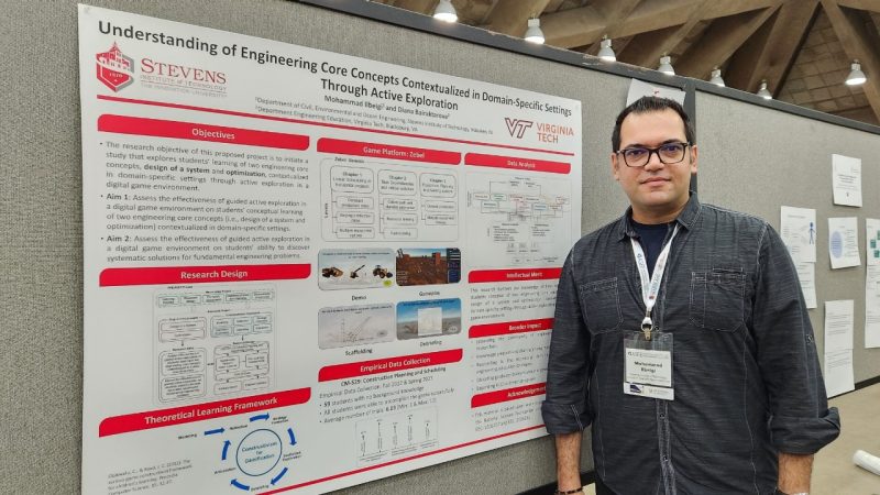 Mohammad Ilbeigi stands in front of his research poster.